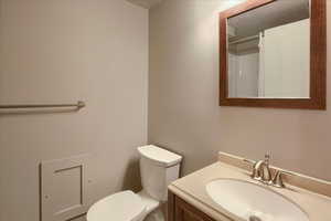 Full bathroom featuring vanity and toilet.