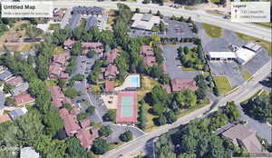 Aerial view of property and surrounding area with nearby suburban area