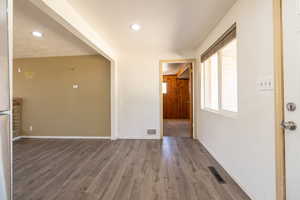 Spare room with wood finished floors and recessed lighting