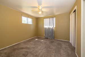 Unfurnished bedroom featuring carpet floors, a closet, and a ceiling fan