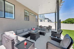 Fenced backyard featuring outdoor lounge area and a patio