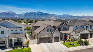 View of front of home with board and batten siding, a residential view, a gate, a porch, and a garage
