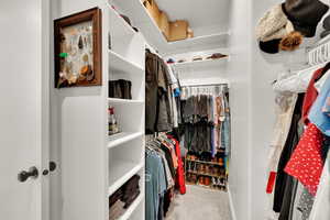Primary suite walk in closet with closet organizers, plenty of room for clothes, hats and shoes!