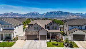 View of front of house with a gate, board and batten siding, a residential view, concrete west facing driveway, and covered porch
