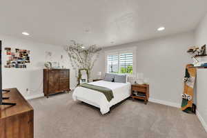 Bedroom 1 with walkin closet, 4.5" plantation shutters, light carpet and recessed lighting,