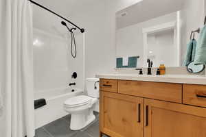 Bathroom 1 Full bath with tile patterned flooring, vanity, and shower / bathtub combination with curtain