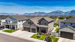 Modern inspired farmhouse featuring a residential view, board and batten siding, concrete driveway, and a gate
