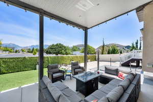 Fenced backyard with an outdoor living space with a fire pit and a patio area