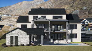 Back of property featuring a balcony, stone siding, stucco siding, a mountain view, and a patio