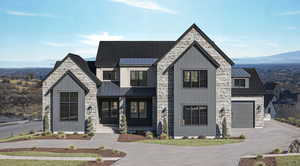 Modern farmhouse style home with stone siding, board and batten siding, and a mountain view