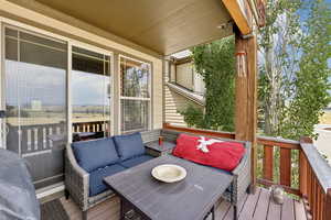 Wooden terrace featuring an outdoor hangout area