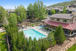 Community pool with a pergola, a residential view, a patio area, and a hot tub