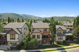 Craftsman-style house featuring a balcony, a residential view, and a mountain view