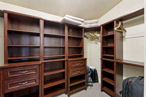 Spacious closet with light carpet