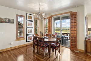 Dining area featuring a chandelier, healthy amount of natural light, and wood finished floors