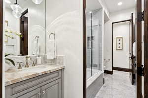 Full bathroom featuring recessed lighting, vanity, and marble finish floors