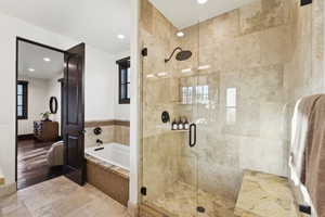 Bathroom with a bath, a shower stall, and recessed lighting