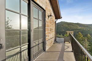 Balcony featuring a mountain view and a forest view
