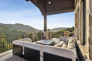 View of patio featuring an outdoor living space and a mountain view