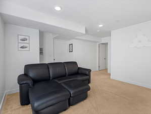 Living room with light carpet and recessed lighting