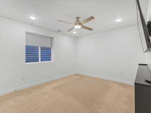 Unfurnished room with light carpet, ceiling fan, and recessed lighting