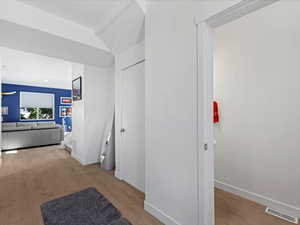 Hallway featuring wood finished floors and baseboards