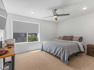 Bedroom with light carpet, recessed lighting, and ceiling fan