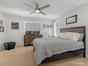Bedroom featuring light carpet, recessed lighting, and a ceiling fan