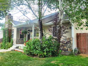 View of front facade with stone siding and roof with shingles