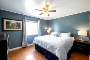 Bedroom with wood finished floors and ceiling fan