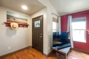 Entryway featuring wood finished floors and baseboards