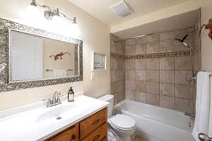 Bathroom featuring washtub / shower combination and vanity