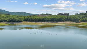 Water view with a heavily wooded area and mountains