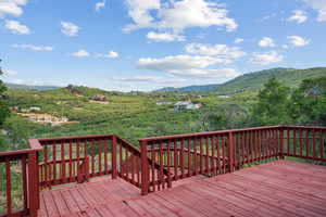 Wooden terrace featuring a mountain view