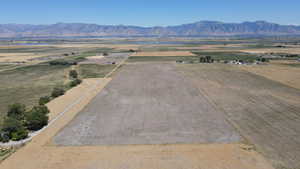 Overview of rural landscape with a mountain backdrop and extensive farmland
