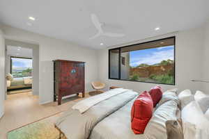 Bedroom with wood finished floors, ceiling fan, and recessed lighting