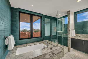 Full bathroom featuring a bath, a shower stall, vanity, and recessed lighting