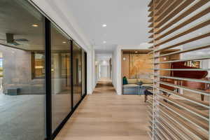 Hall with recessed lighting and wood finished floors