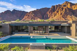 Outdoor pool featuring a mountain view and a patio