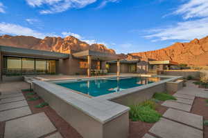 View of pool with a mountain view and a patio