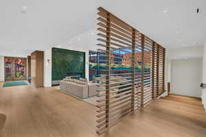 Corridor featuring light wood-style floors, recessed lighting, and french doors