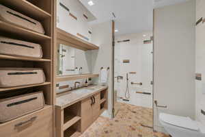 Full bathroom featuring a shower stall and vanity