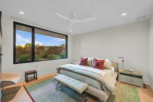 Bedroom with wood finished floors, recessed lighting, and a ceiling fan