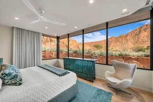 Bedroom featuring a mountain view, wood finished floors, a ceiling fan, and recessed lighting