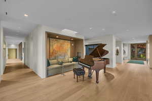 Living room featuring light wood finished floors and recessed lighting