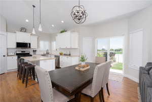 Dining room featuring a chandelier, light wood finished floors, and recessed lighting
