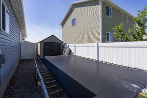 Fenced backyard with a shed