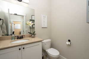 Half bathroom with toilet and vanity