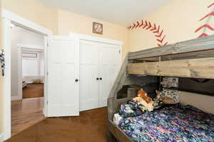 Carpeted bedroom featuring a closet