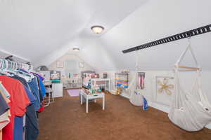 Bonus room with carpet flooring and lofted ceiling